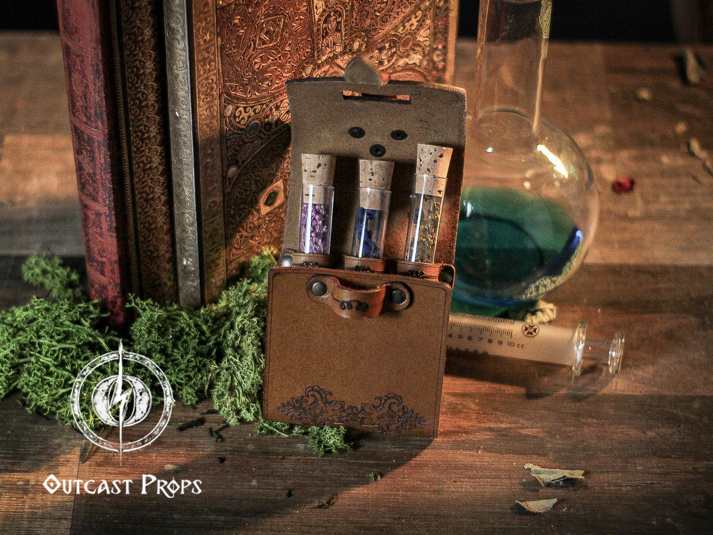 Vintage-style prop box with test tubes and a glass flask on a wooden surface, featuring 'Outcast Props' branding. Leather Vial Case for 3 plastic vials. Adventurers, steampunk, alchemist, healers, cosplay or just to keep spices