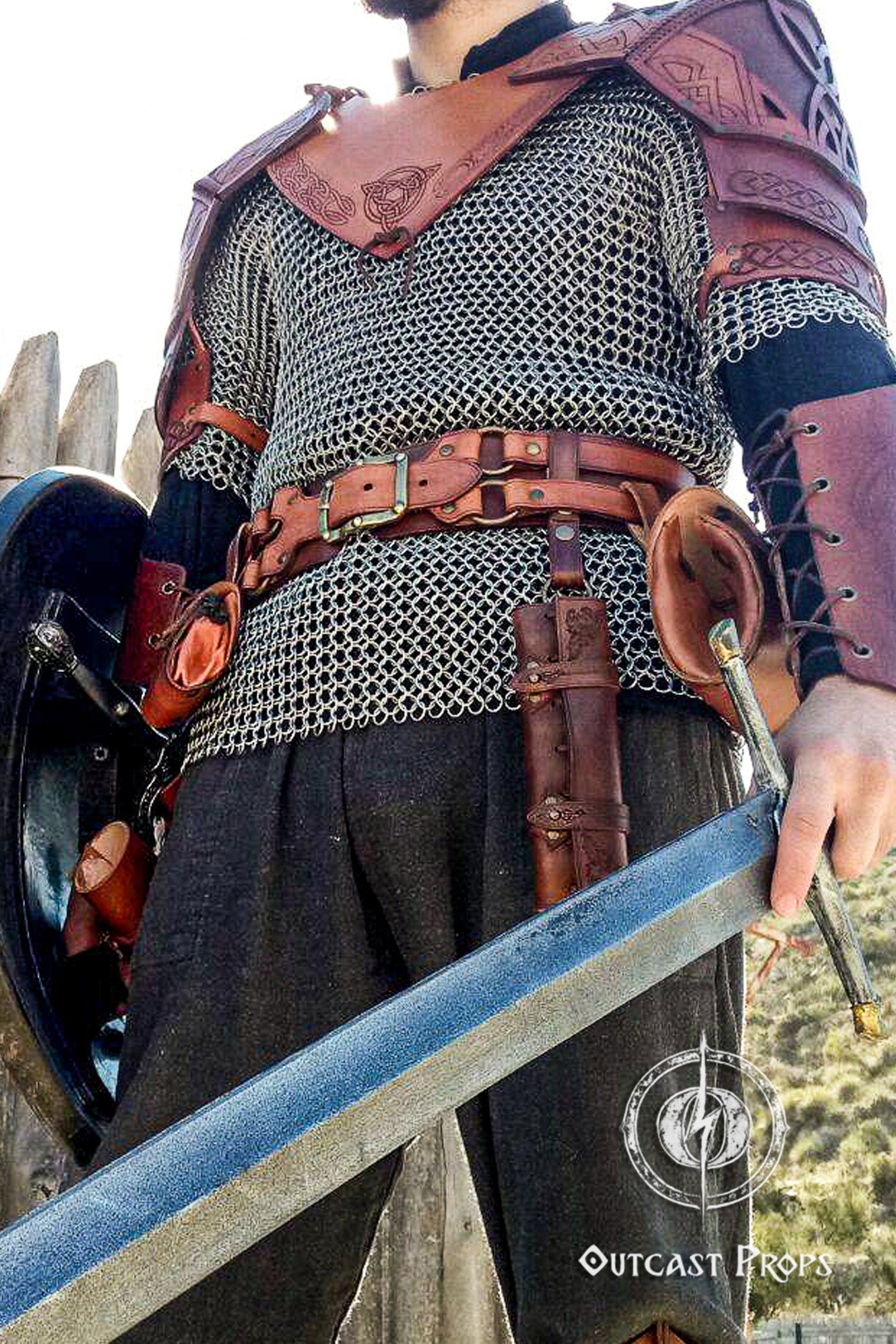 Person wearing medieval armor with chainmail and leather accents, holding a sword. 6 Small Potion leather case, vertical belt kit for LARP, Cosplay and Costume. Easily Carry six strong cristal bottle with cork