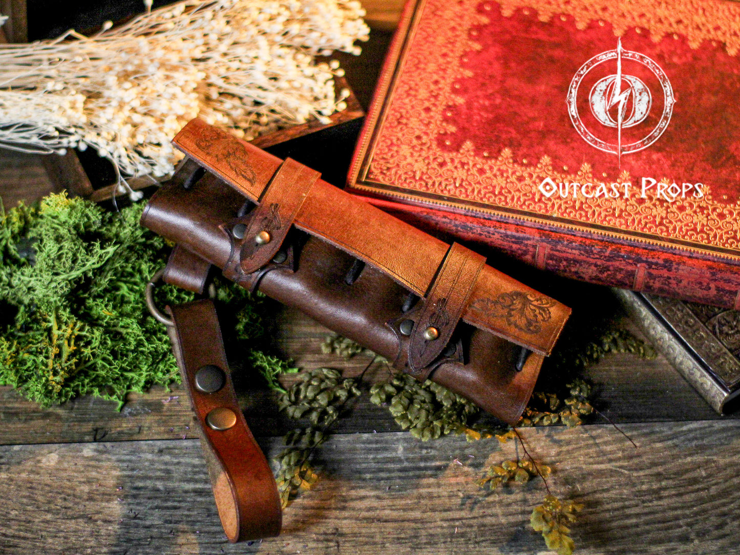 Brown leather belt with a buckle on a wooden surface with a red box labeled 'Outcast Props' in the background. 6 Small Potion leather case, vertical belt kit for LARP, Cosplay and Costume. Easily Carry six strong cristal bottle with cork