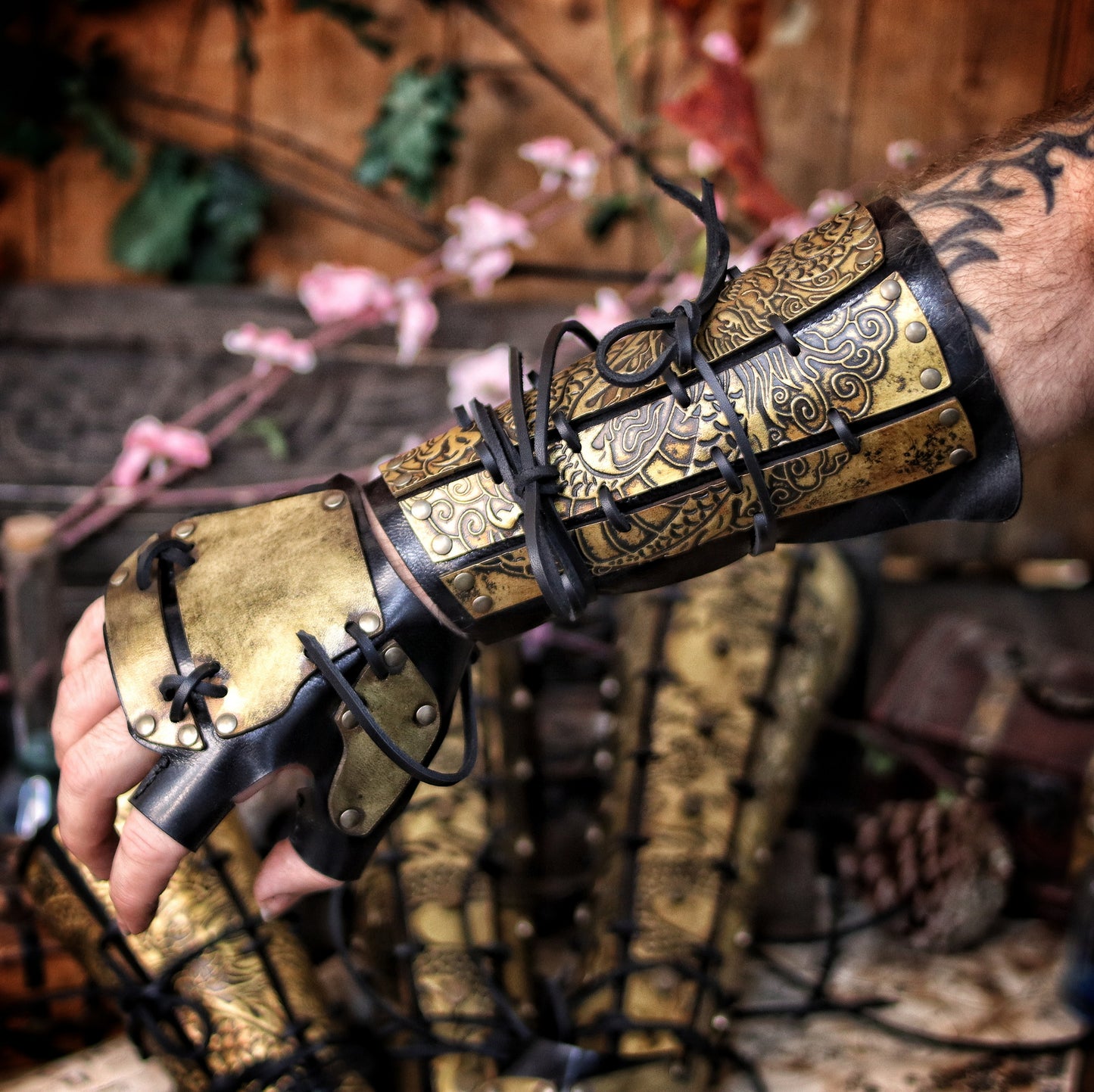 Worn view of leather dragon bracers with matching hand protection, perfect for samurai armor cosplay and fantasy larp costumes. Designed with golden engraved leather plates and flexible base. A unique costume piece for players portraying disciplined warriors, monks, or eastern nobles. Handcrafted using vegetable-tanned leather, natural dyes, and aged with epic finish. Great for roleplay and immersive adventures.