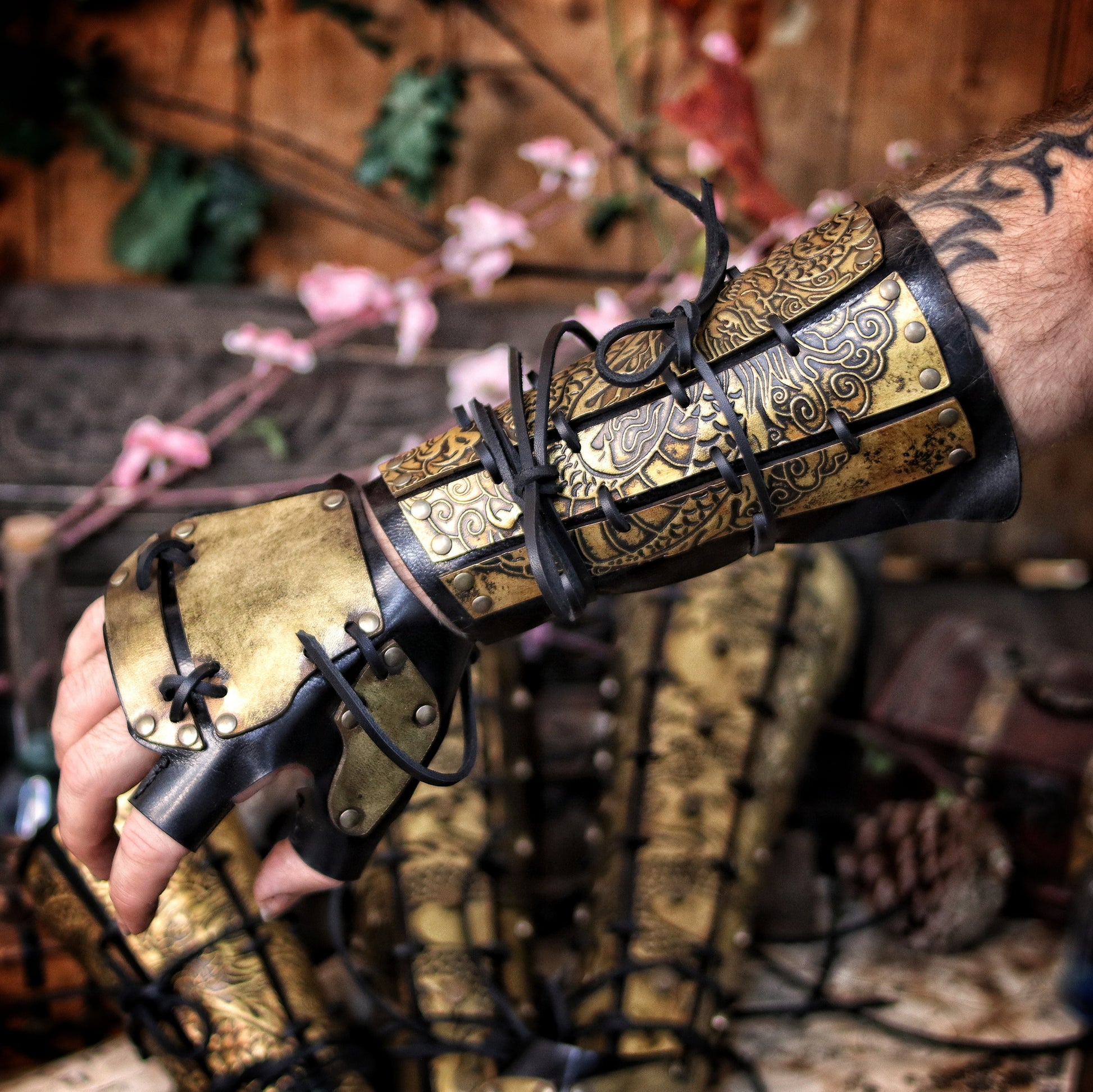 Worn view of leather dragon bracers with matching hand protection, perfect for samurai armor cosplay and fantasy larp costumes. Designed with golden engraved leather plates and flexible base. A unique costume piece for players portraying disciplined warriors, monks, or eastern nobles. Handcrafted using vegetable-tanned leather, natural dyes, and aged with epic finish. Great for roleplay and immersive adventures.