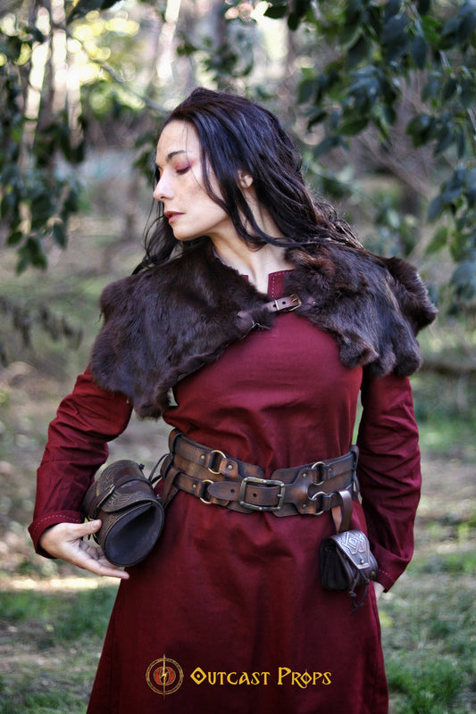 LARP adventurer outfit featuring a fur shoulder mantle, red medieval dress, and the adjustable leather belt with two pouches. This handmade fantasy belt is perfect for immersive role-playing, allowing you to carry tools, scrolls, and healing potions securely. The adventurer leather belt for steampunk and medieval cosplay fits over armor or robes, adding a rugged, authentic touch to your costume ensemble.