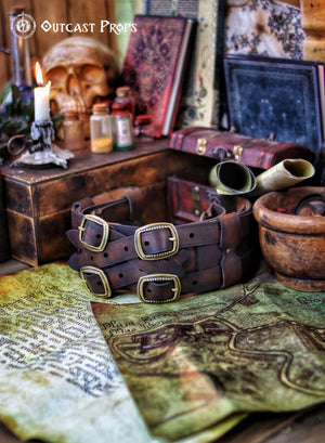 Rear view of a Rustic adventurer leather belt displayed atop a fantasy map with scrolls and potion bottles. This steampunk wide leather belt is handmade from full-grain leather, aged for a battle-worn finish. Perfect for cosplay, pirate reenactments, and Renaissance fairs, it offers adjustable comfort and accessory loops. A versatile and durable LARP belt for medieval and fantasy role-playing characters.