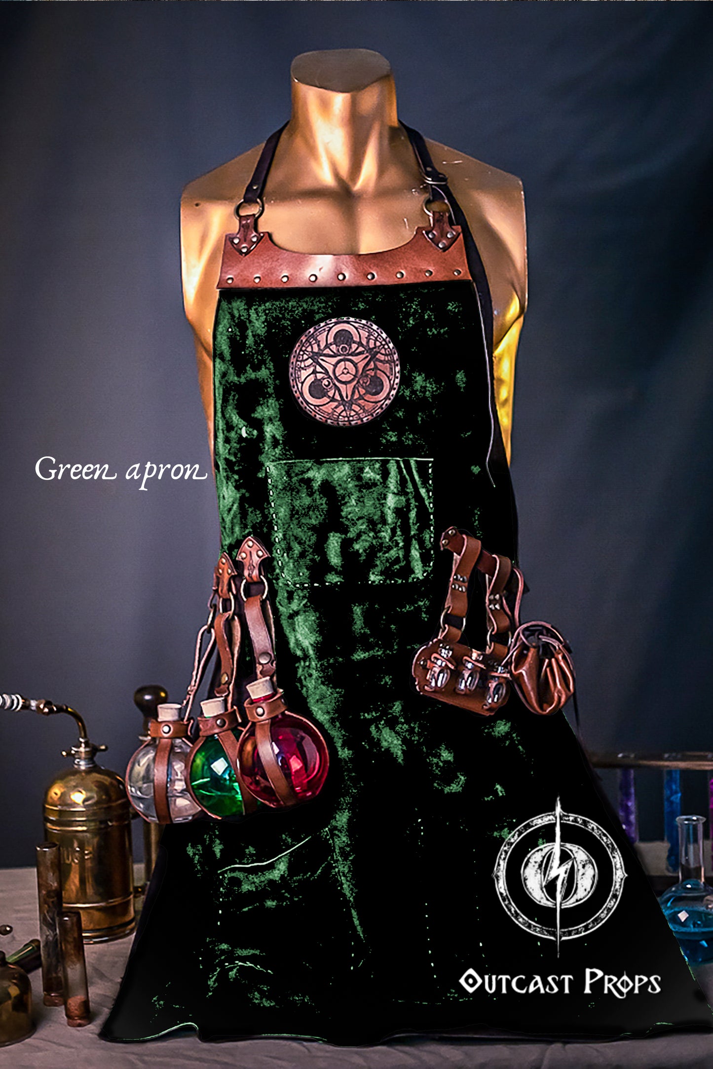 Green apron with decorative elements on a mannequin against a dark background, featuring 'Outcast Props' branding.