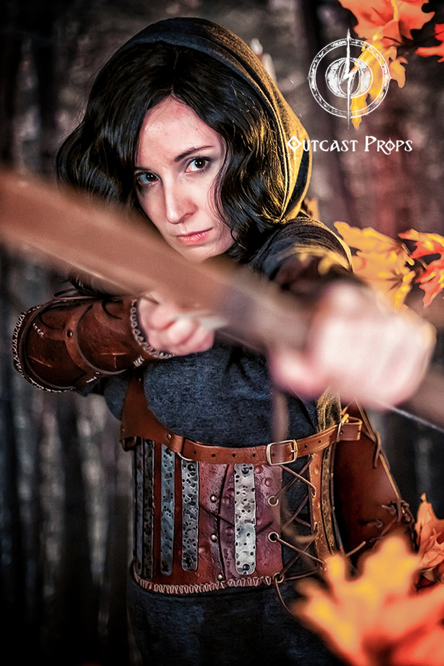Person in medieval costume holding a bow with 'Outcast Props' branding. Barbarian Leather armor woman, larp armor woman viking piece woman post apocalyptic cosplay