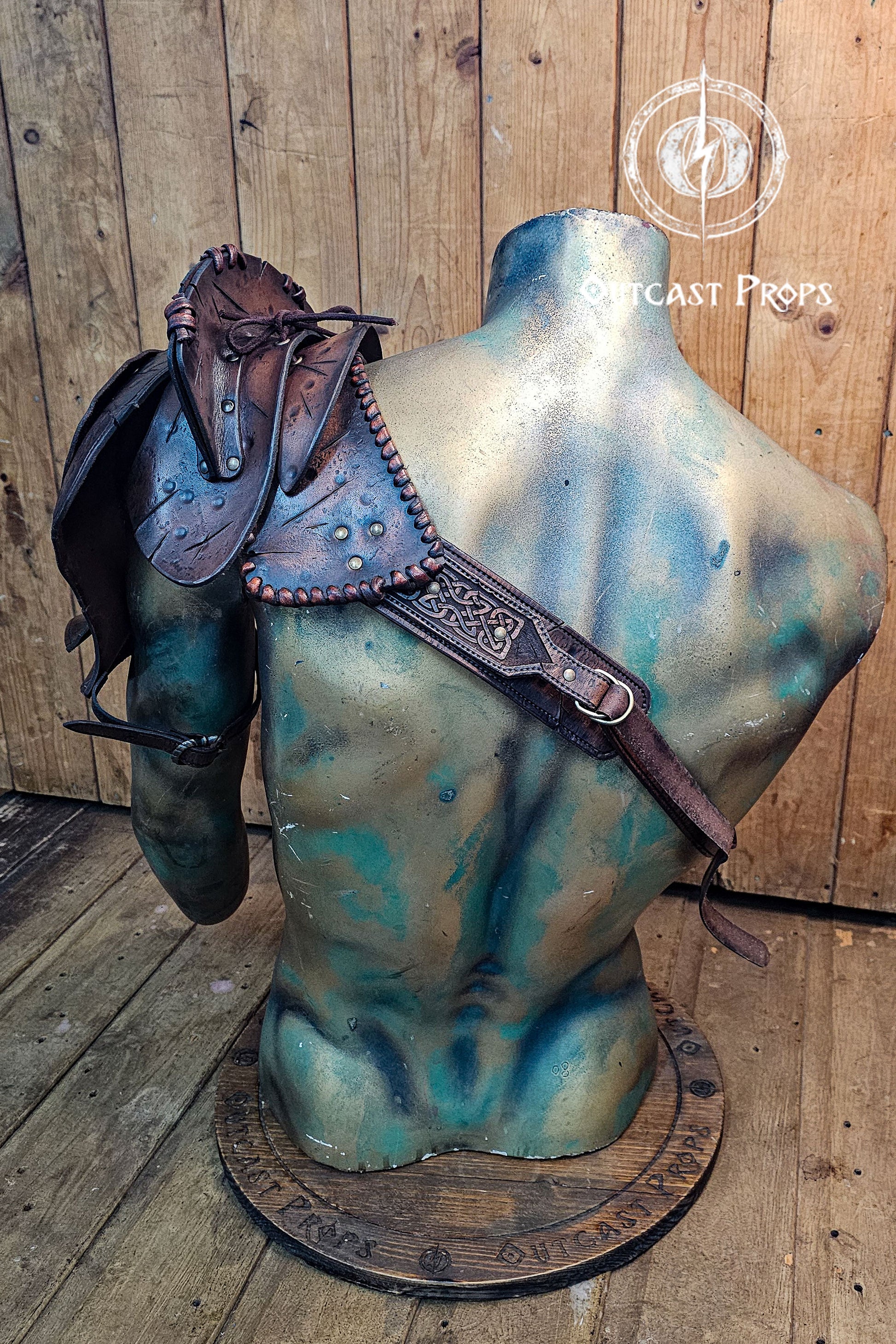 Barbarian Viking Leather Shoulder armor set. Mannequin torso with a leather saddle on a wooden background