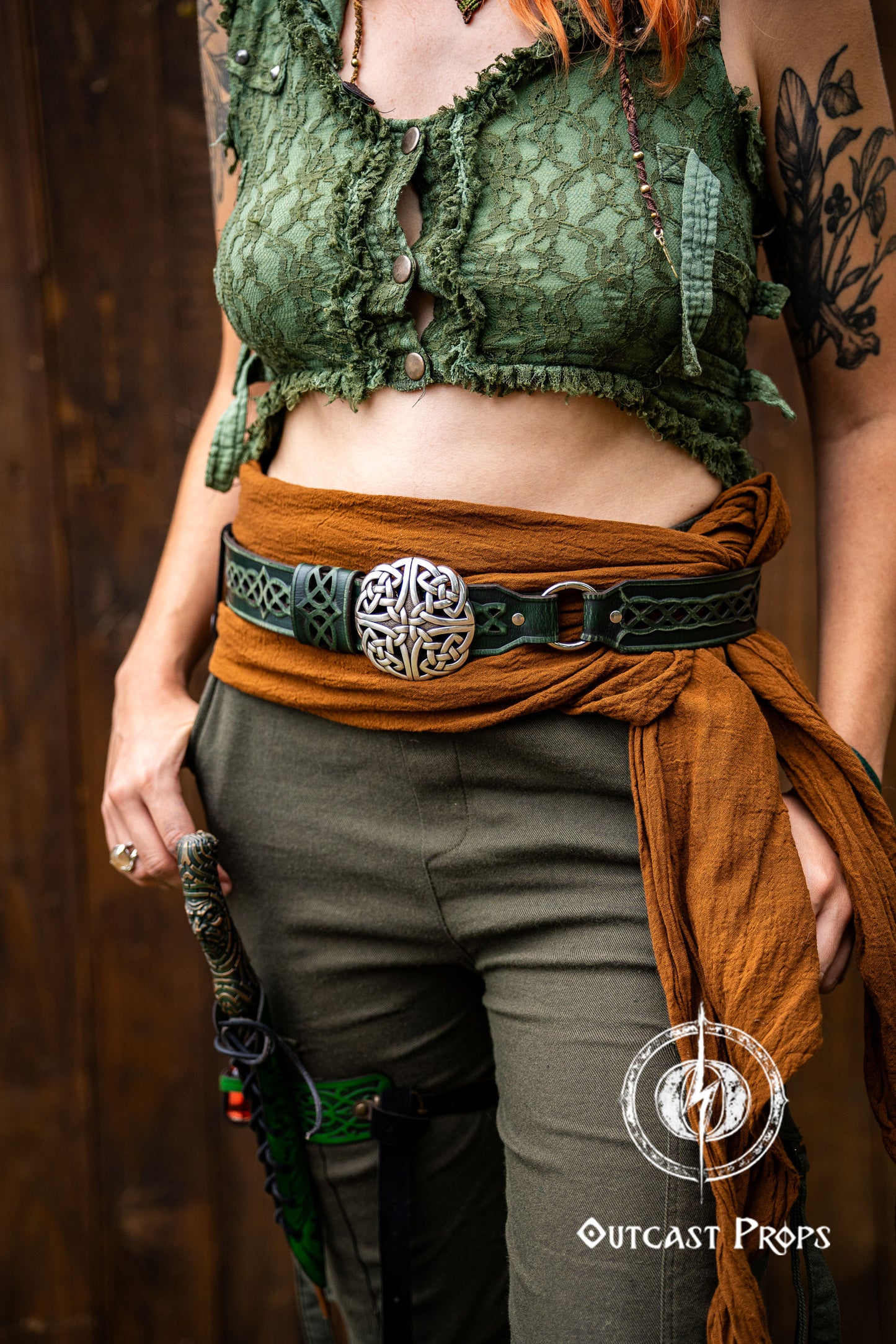 Person wearing a green lace top, brown sash, and green pants with a belt buckle. Celtic knot leather belt silver buckle larp belt for ren fair fantasy costume celtic belt unisex leather belt for renaissance outfit