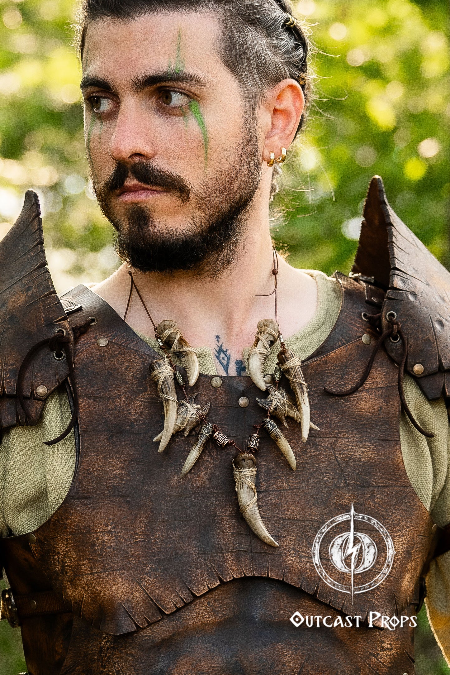 Man wearing a detailed leather armor with decorative elements, outdoors. Celtic Tusk Necklace Viking ornament Tribal Shaman Druid with realistic resin fangs Orc LARP cosplay and post-apocalypse marauder