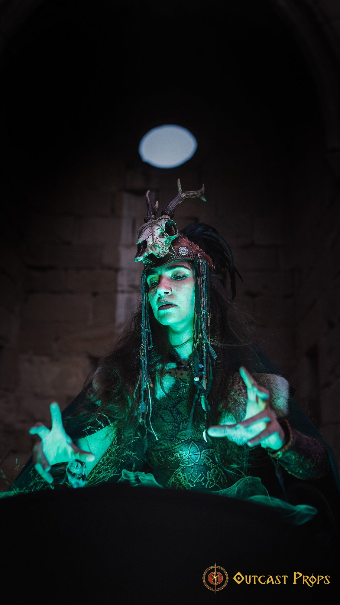 A Celtic adorned tiara with a resin skull, deer horns, feathers, bone pieces, beads, and fangs. Beltane Headpiece tribal deer horns skull and feathers tiara leather and resin