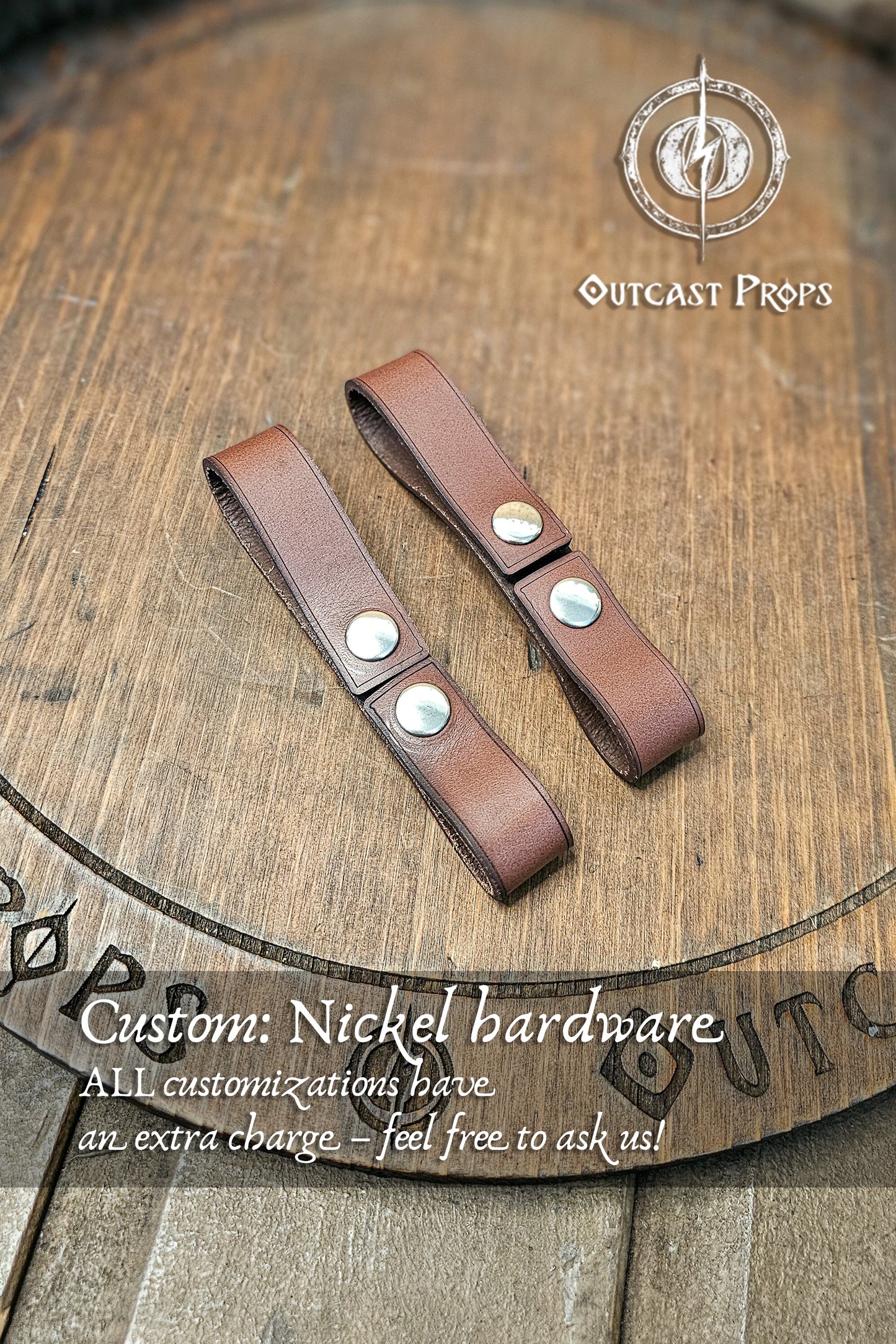 Pair of brown leather straps with nickel hardware on a wooden surface, featuring Outcast Props logo. Leather belt pair of clasp mug holder belt strap medieval accessory set of two for LARP cosplay renaissance fair Handcrafted Vegetal Tanned