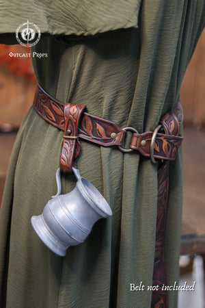 Brown leather belt with a silver cup holder worn by a person in green fabric, Outcast Props logo visible.