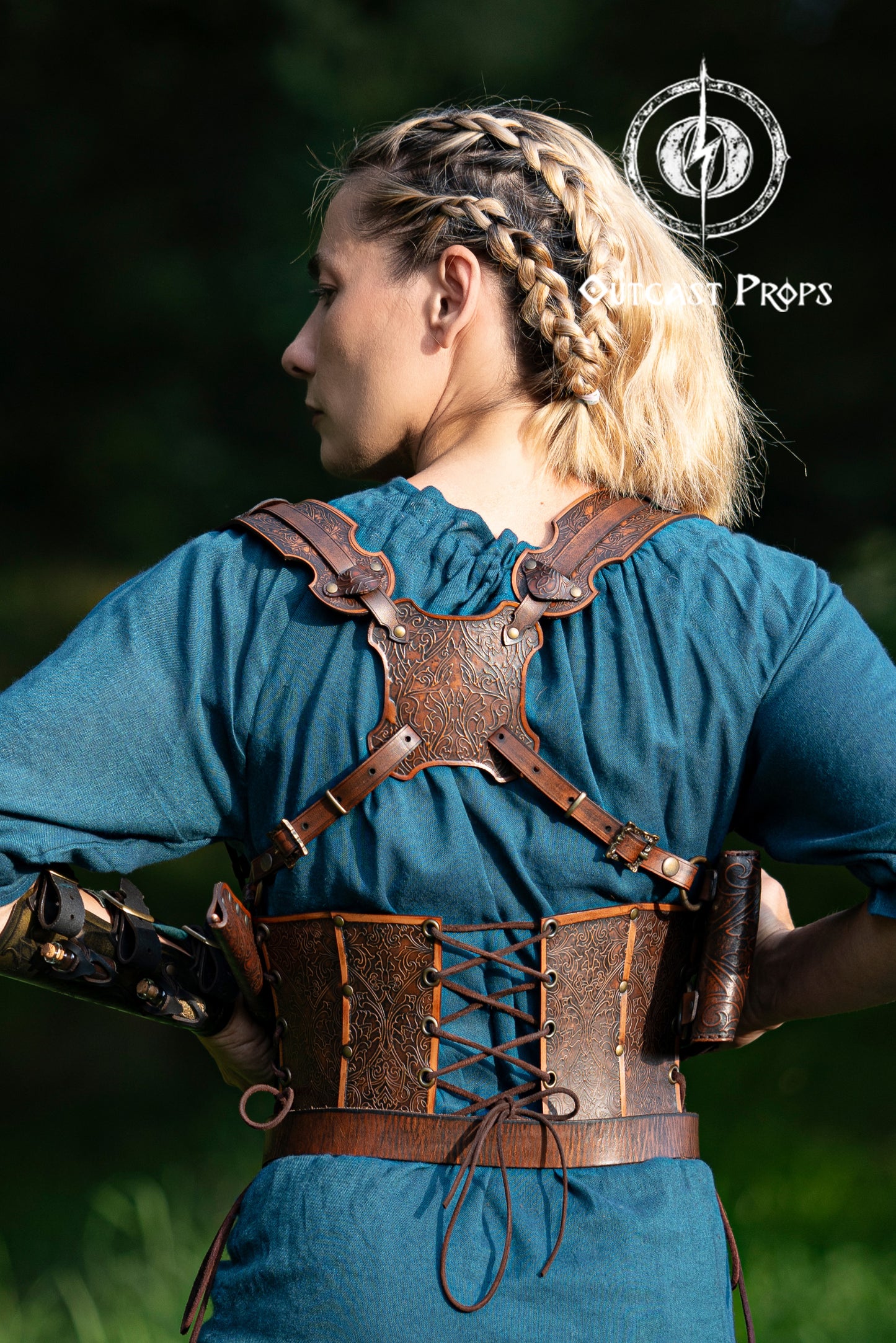 Ornated Magic Wand shoulder Holster full-grain leather with potions for wizards and witches. Dark Academy style. MACUSA Cosplay and LARP. A person wearing a white shirt and a shoulder holster in a patterned fabric. The holster is brown, made of leather, and designed to hold a wand.