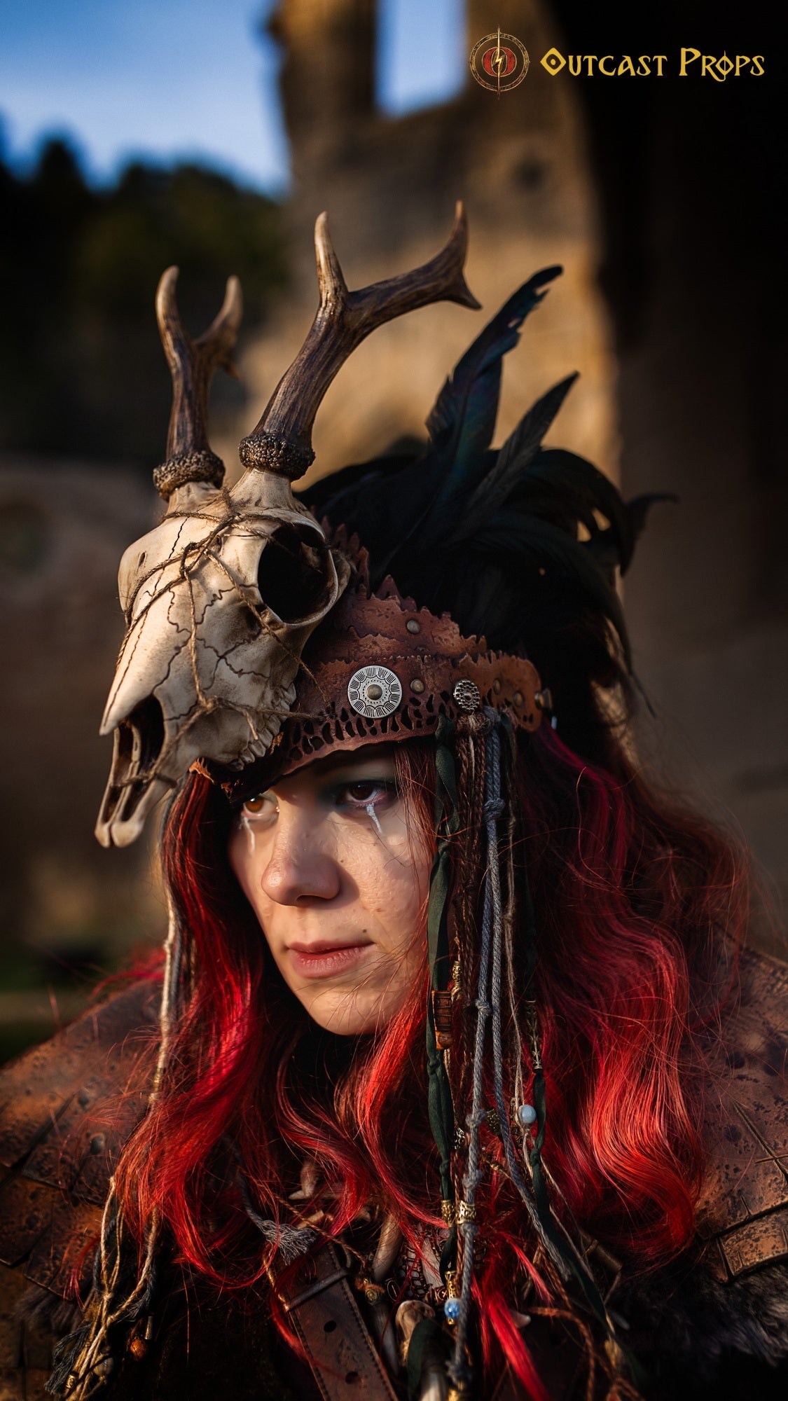 A Celtic adorned tiara with a resin skull, deer horns, feathers, bone pieces, beads, and fangs. Beltane Headpiece tribal deer horns skull and feathers tiara leather and resin
