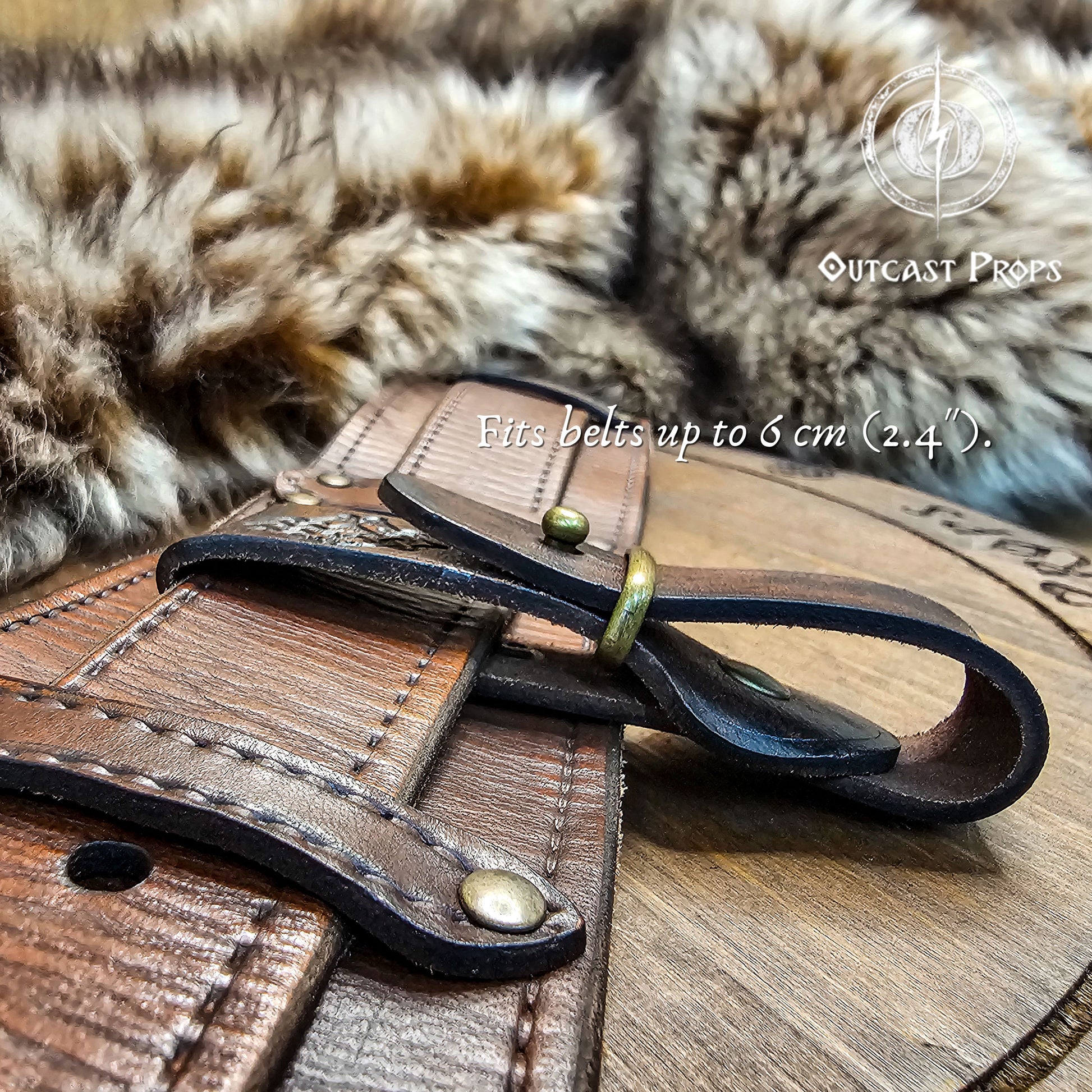 Leather belt with metal buckle on a wooden surface, with 'Outcast Props' branding. Medieval Leather Tankard Strap: Renaissance Faire Belt up to 6 cm or 2,4 inches. Accessory for Viking Cosplay, LARP, and Celtic Costumes