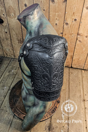 Decorative leather arm guard with intricate patterns on a wooden background. Leather Shoulder Pauldron: Musketeer Armor for LARP, Renaissance LARP, cosplay, Ren Faire accessory, Aramis inspired