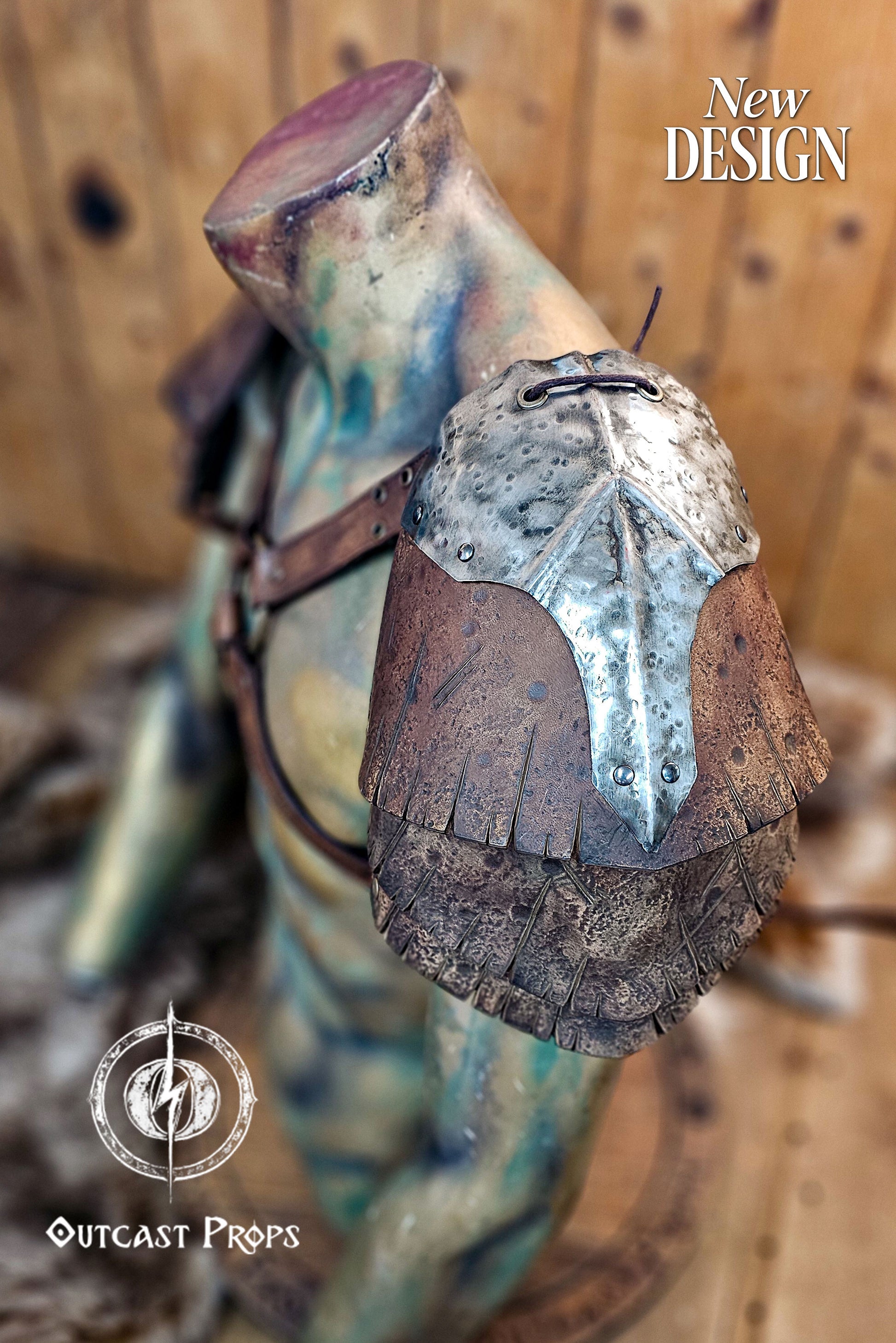 Side view of the Viking and ork-inspired leather pauldron showing detailed hammered metal and aged brown leather layers. The piece rests on a chest harness with riveted straps for secure fit. Outcast Props’ design blends brutal realism and historical style, perfect for barbarian, LARP, and fantasy cosplay warriors seeking handcrafted cinematic armor. Barbarian Leather and Metal Pauldron Set for LARP Viking Warrior or Ork Cosplay Armor Shoulder Pads for Post Apocalyptic Costume