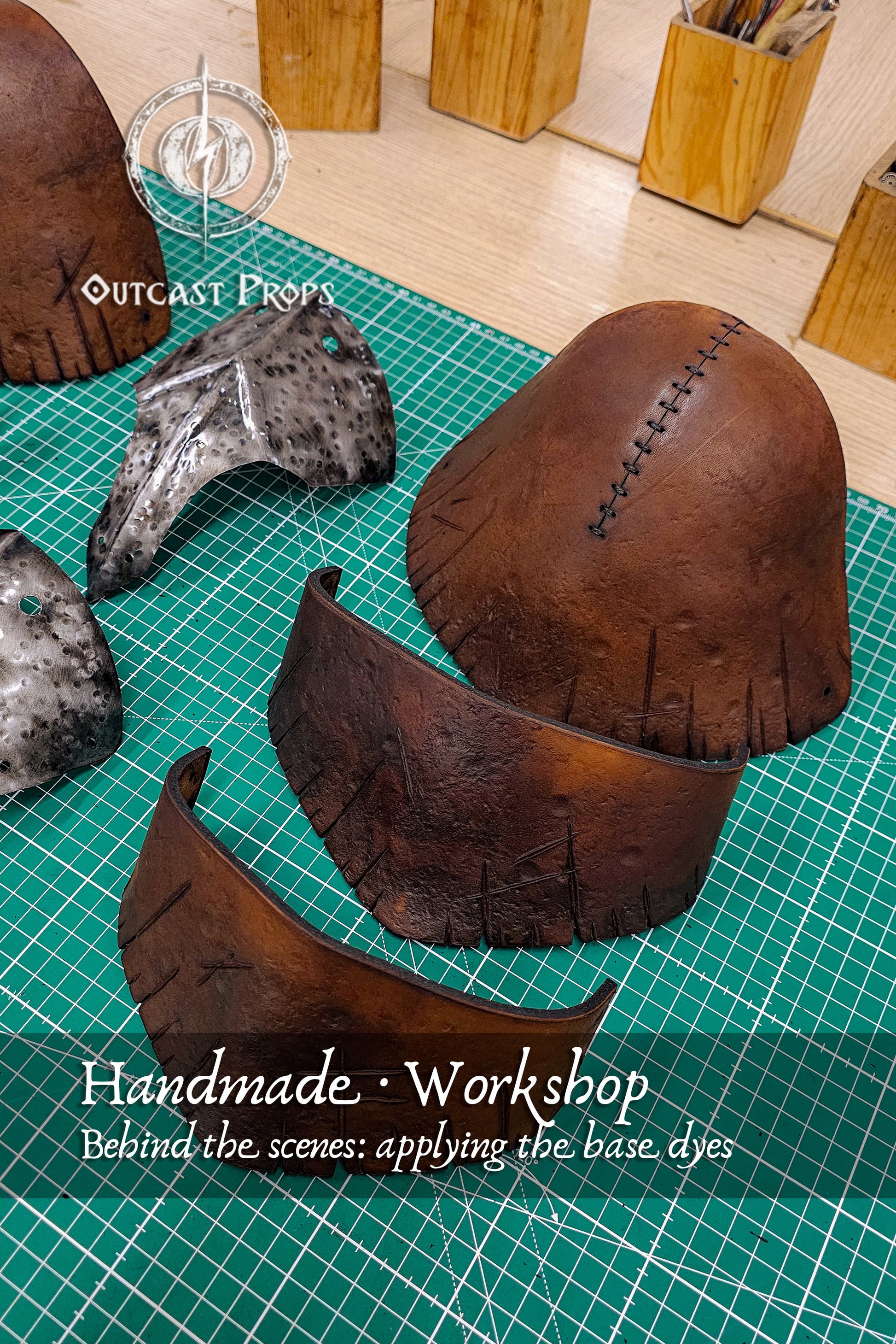 Partially dyed leather pauldron components and hammered metal plates on a green cutting mat. The photo shows the transition from raw leather to aged armor through water-based vegetable dyes. Each Viking and ork-inspired plate is painted by hand, part of Outcast Props’ eco-friendly process to achieve realistic, cinematic armor finishes. Barbarian Leather and Metal Pauldron Set for LARP Viking Warrior or Ork Cosplay Armor Shoulder Pads for Post Apocalyptic Costume