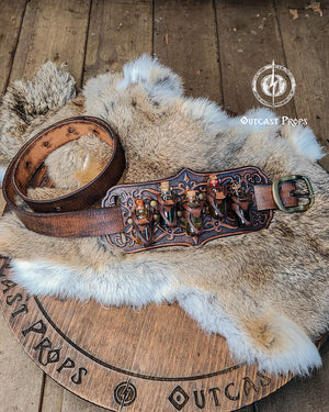 A handmade leather potion holder with ornate embossed patterns, designed to hold five small glass vials. The holder is displayed on a furry surface, and the vials have cork stoppers. Ornated Belt potion holder | 5 potion Belt carrier | LARP, cosplay, fantasy alchemist accessory, adventurers, steampunk, alchemist, healers