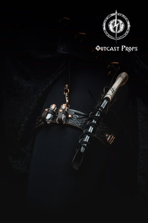 Close-up of a dark-themed outfit with a leather thigh garter worn over black fabric. The garter features Celtic embossed leather, two glass potion vials secured with riveted loops, and a wooden wand held in a laced leather holster. This handcrafted accessory is ideal for LARP wand holster, dark wizard garter belt, and thigh wand holder for cosplay. Great visibility of textures and functionality for blind users.