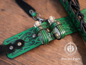 Green version of the leather garter worn on thigh. Wand is secured with black lacing, two potion bottles held by matching green leather straps. The embossed central piece shows detailed elven design. Great for green wizard potion garter, fantasy LARP thigh wand holster, elven magic accessory for cosplay outfits.