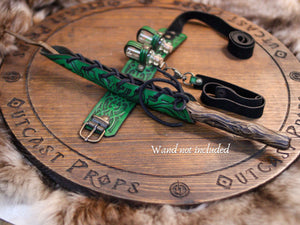 Green leather belt with gold buckles on a wooden surface with 'Outcast Props' branding.