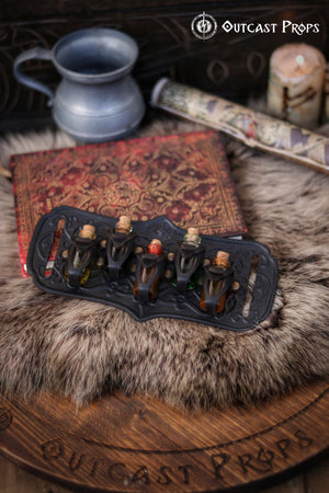 A handmade leather potion holder with ornate embossed patterns, designed to hold five small glass vials. The holder is displayed on a furry surface, and the vials have cork stoppers. Ornated Belt potion holder | 5 potion Belt carrier | LARP, cosplay, fantasy alchemist accessory, adventurers, steampunk, alchemist, healers