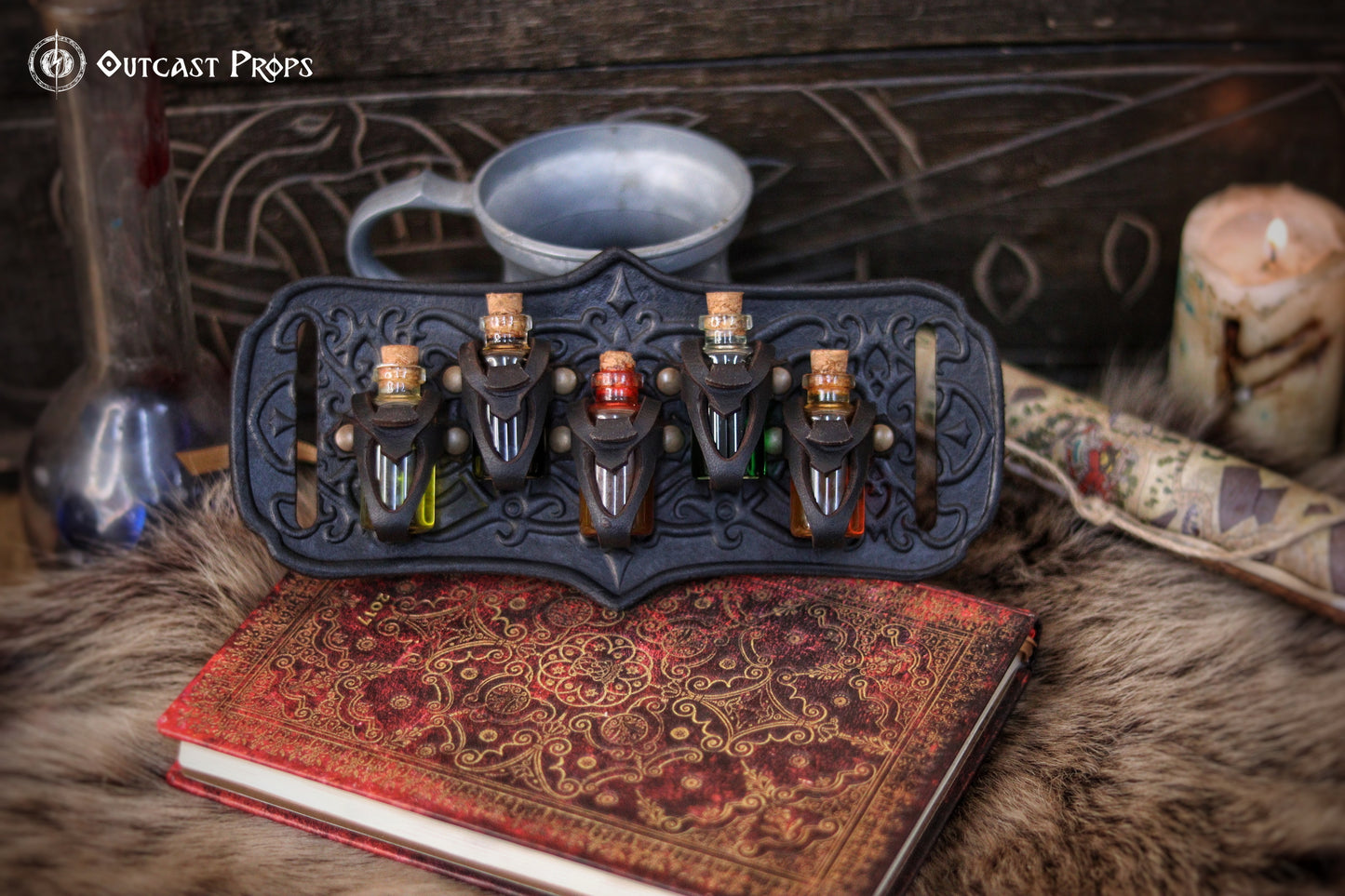 A handmade leather potion holder with ornate embossed patterns, designed to hold five small glass vials. The holder is displayed on a furry surface, and the vials have cork stoppers. Ornated Belt potion holder | 5  potion Belt carrier | LARP, cosplay, fantasy alchemist accessory, adventurers, steampunk, alchemist, healers