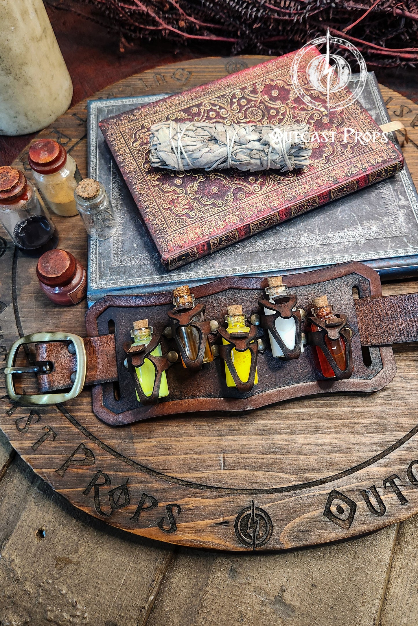 Brown belt with small bottles and a book on a rustic surface. Belt Potion holder for 5 small bottles. Made of leather for adventurers, steampunk, alchemist, healers, cosplay or just to keep spices