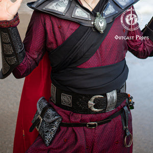 Person wearing a detailed costume with armor and Outcast Props branding. Ramattush Persian Leather Broadbelt, ornamental Arabic and Persian courts inspired, larp oriental leather belt, fantasy belt, renfaire belt. Jafar cosplay costume. Aladdin cosplay.