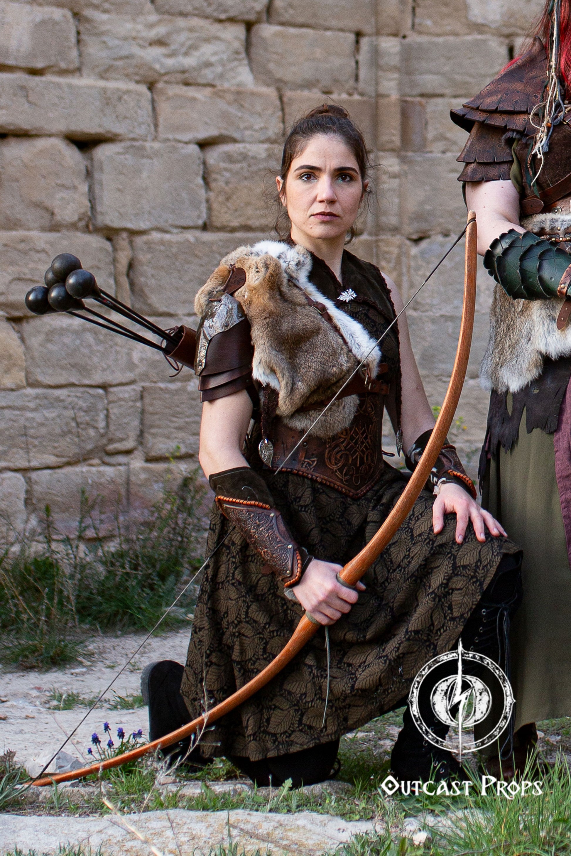 Person in medieval or fantasy costume holding a bow against a stone wall. Leather quiver elven quiver archery quiver arrow quiver larp quiver elf quiver bow quiver leather arrow quiver quivers for arrows cosplay