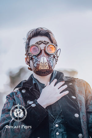 Person wearing a steampunk-style mask with goggles and a detailed design, standing against a blurred background. Alchemist's Wooden Steampunk Goggles: Medieval LARP Eyewear for Fantasy Costumes & Renaissance Fairs