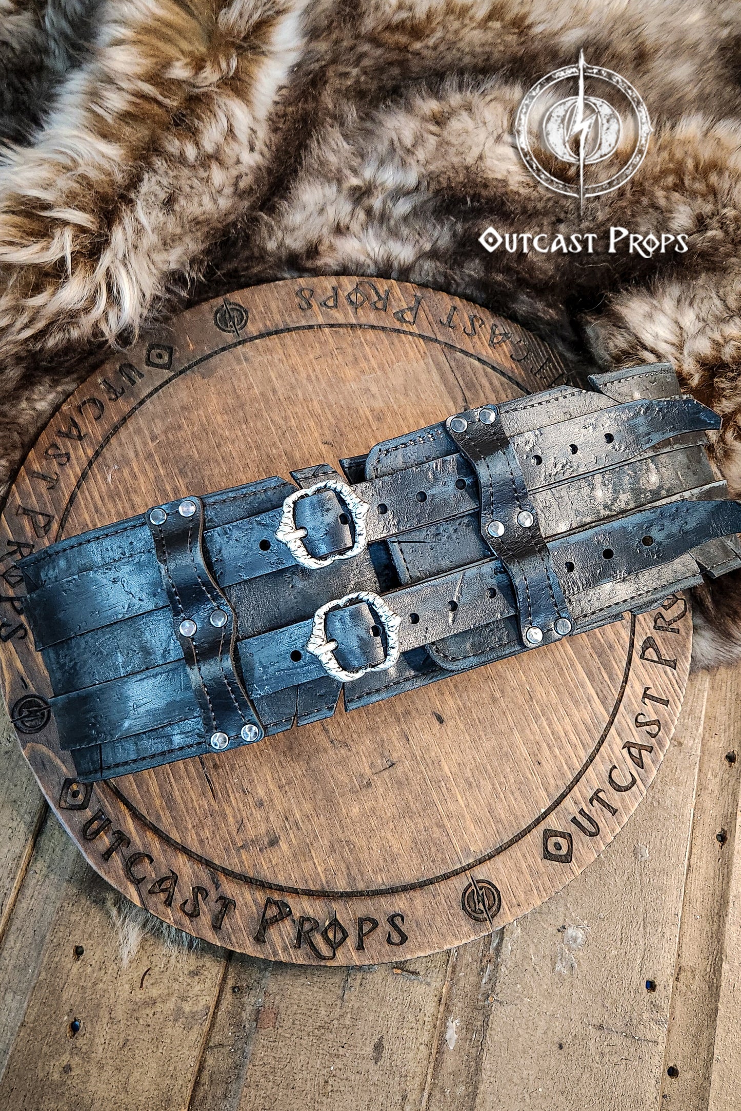 Black doble leather broadbelt with silver buckles on a wooden surface with 'Outcast Props' branding. Veteran Leather Belt. Medieval leather belt. Orc belt. Warrior belt for larp.