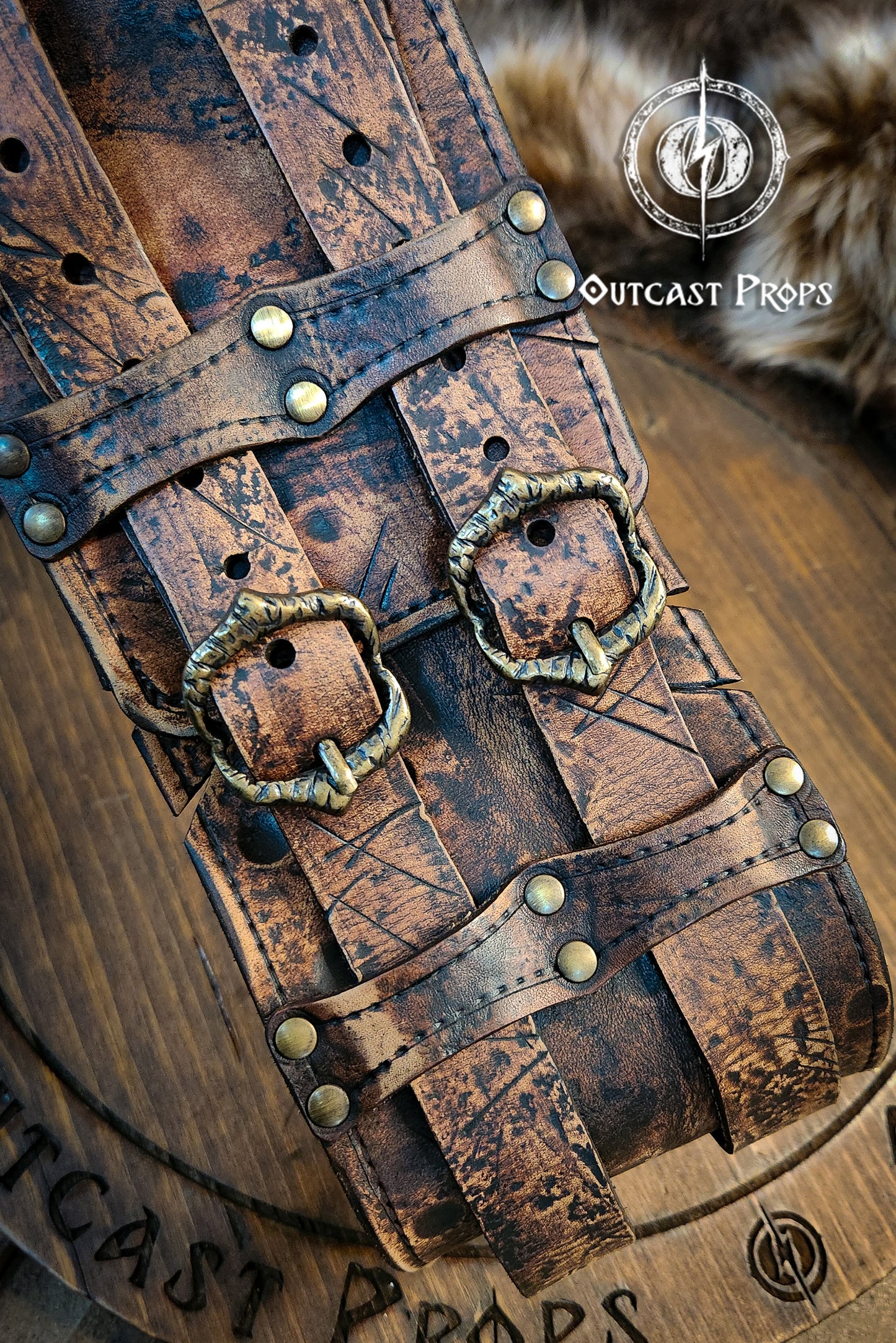 Brown leather belt with brass buckles on a wooden surface, featuring 'Outcast Props' branding. Brown doble leather broadbelt with silver buckles on a wooden surface with 'Outcast Props' branding. Veteran Leather Belt. Medieval leather belt. Orc belt. Warrior belt for larp.