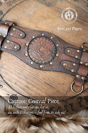 Custom engraved central pieces for the viking leather armor belt. Three variants shown: Valknut, wolf head, and tribal bear paw, all framed by knotwork and rivets. Displayed over rustic wood and fur. Keywords: celtic fantasy belt, barbarian cosplay outfit, medieval warrior armor, LARP belt customization, renfaire costume wide.