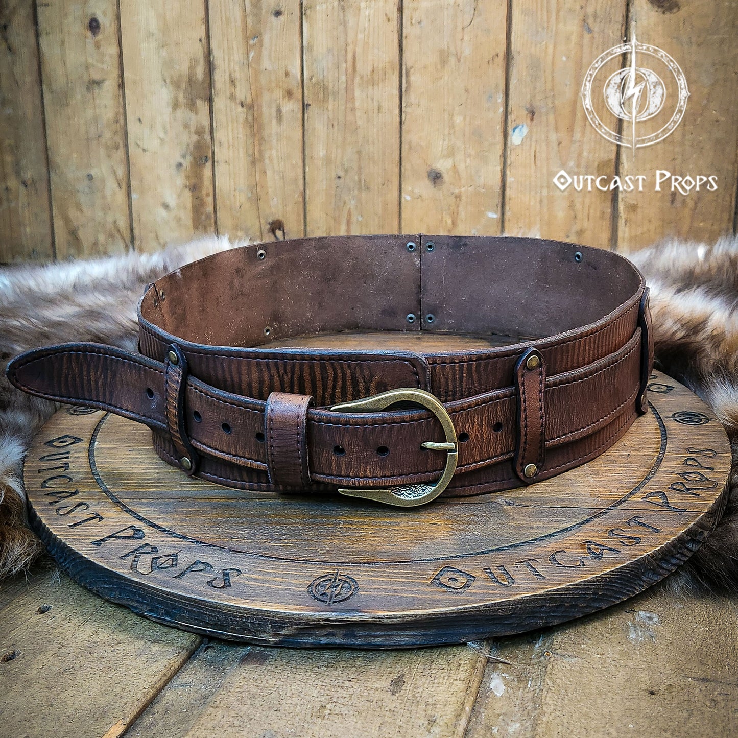 Brown leather belt with brass buckle on a wooden surface, branded 'Outcast Props'. Medieval broadbelt for larp or cosplay. Elegant leather belt. Celtic knot leather belt silver buckle larp belt for ren fair fantasy costume celtic belt unisex leather belt for renaissance outfit