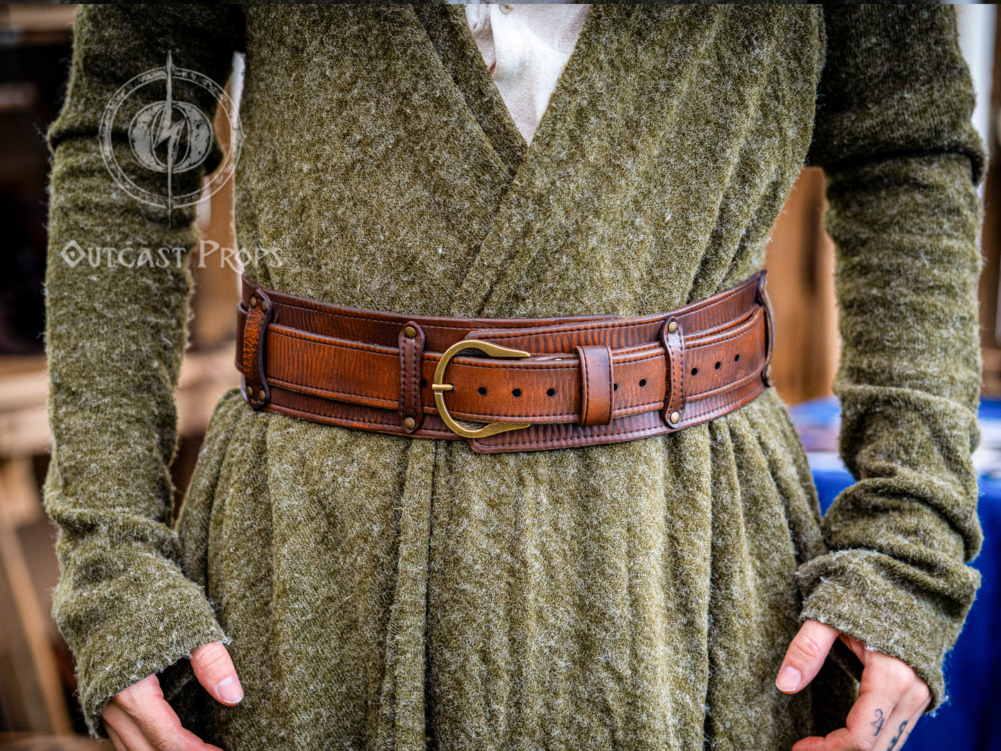 Person wearing a green textured garment with a brown leather belt. Celtic knot leather belt silver buckle larp belt for ren fair fantasy costume celtic belt unisex leather belt for renaissance outfit
