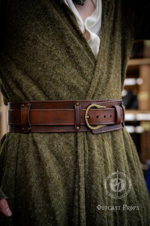 Person wearing a green robe with a brown belt in an indoor setting. Celtic knot leather belt silver buckle larp belt for ren fair fantasy costume celtic belt unisex leather belt for renaissance outfit