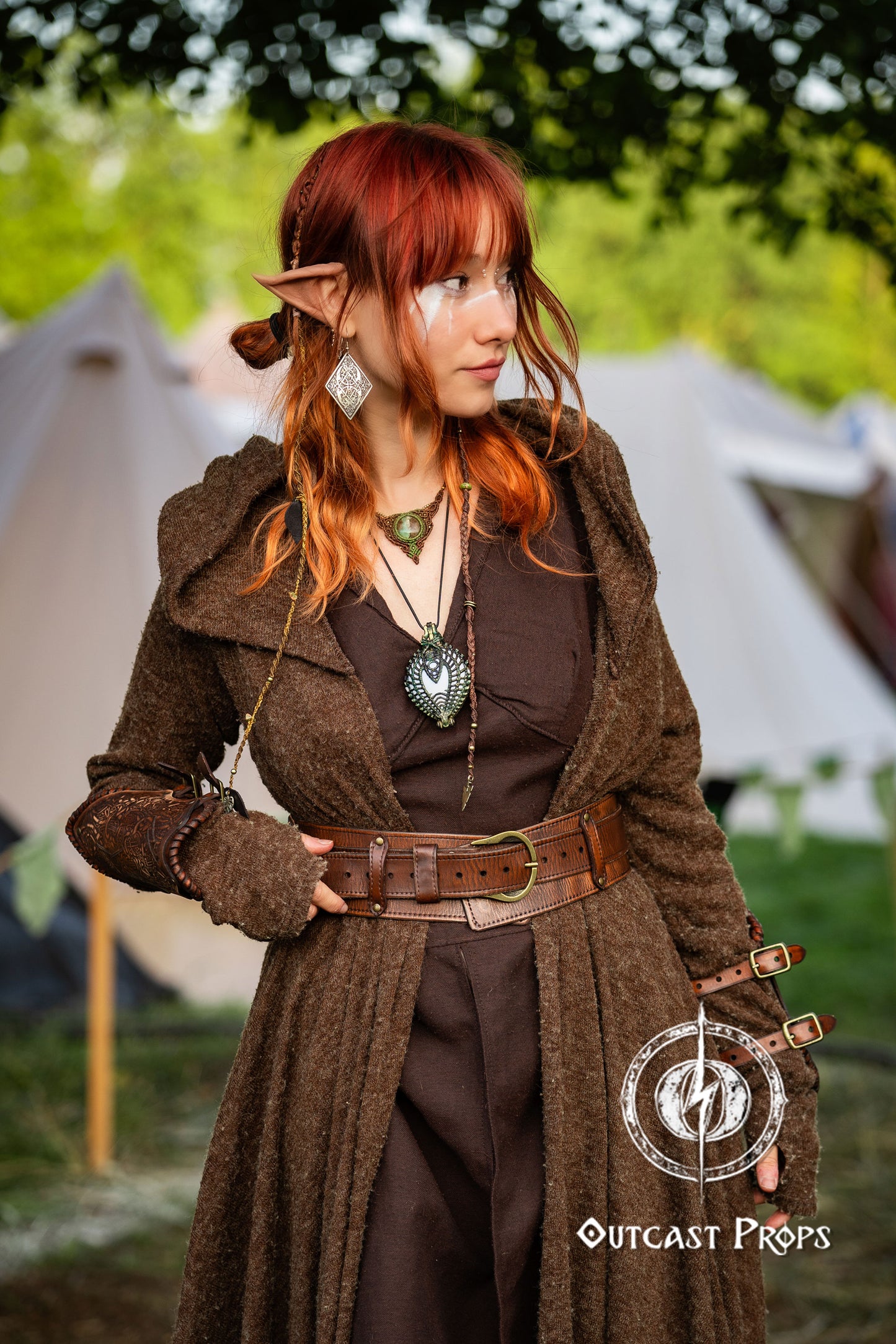 Person in fantasy costume with red hair and elven accessories outdoors with tents in the background. Celtic knot leather belt silver buckle larp belt for ren fair fantasy costume celtic belt unisex leather belt for renaissance outfit