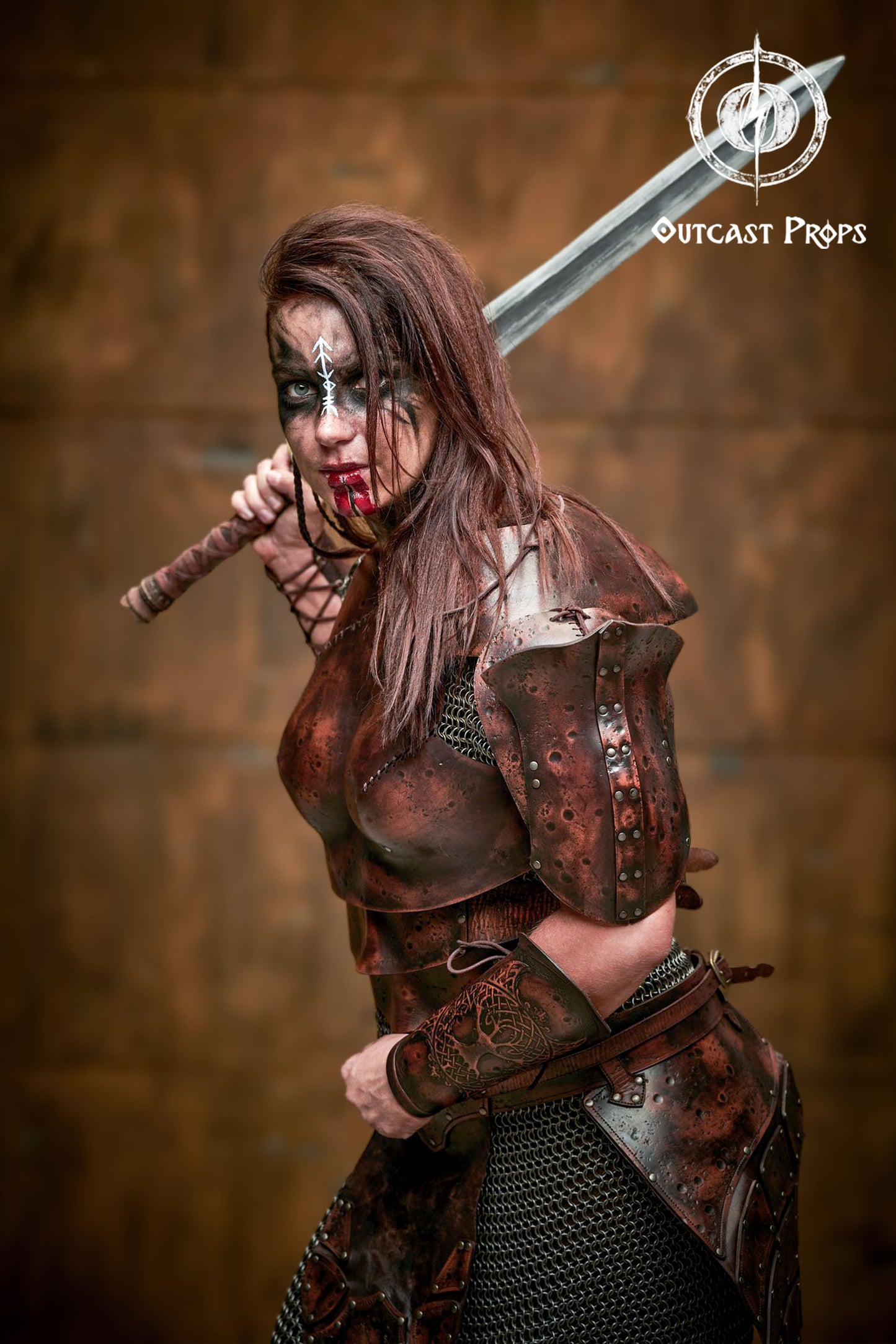 Female warrior in action pose, wearing full handcrafted female leather armor with distressed finish, chainmail, and a painted sword. Ideal for viking armor women cosplay, LARP or fantasy character outfits. The armor’s anatomical chestplate and shoulder guards enhance mobility and presence. Face painted with war symbols, embodying a fierce ranger or barbarian character ready for battle.