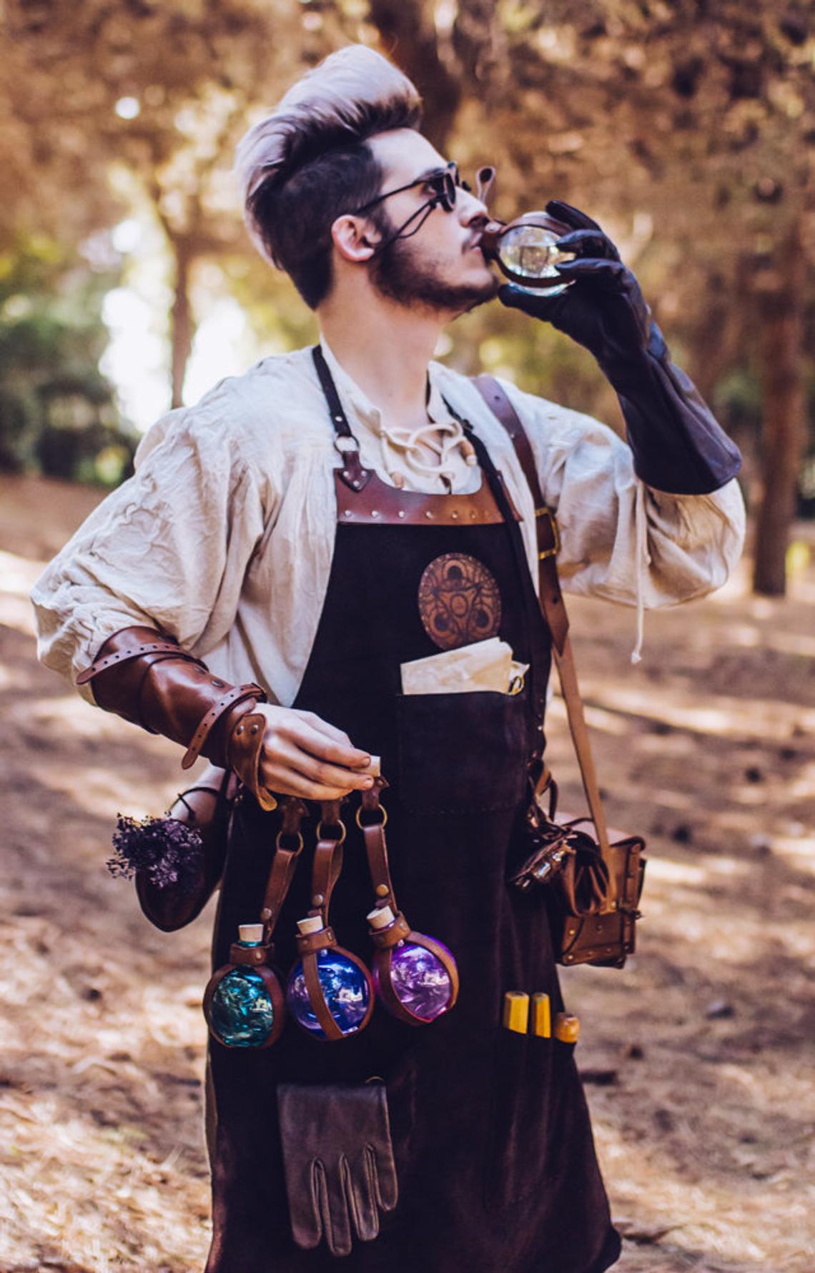 A person wearing a brown leather apron with pockets and a potion holder with glass bottles. Leather Apron, larp Alchemy steampunk crazy scientist mechanics, engineers. With accesories and pockets perfect for Barber