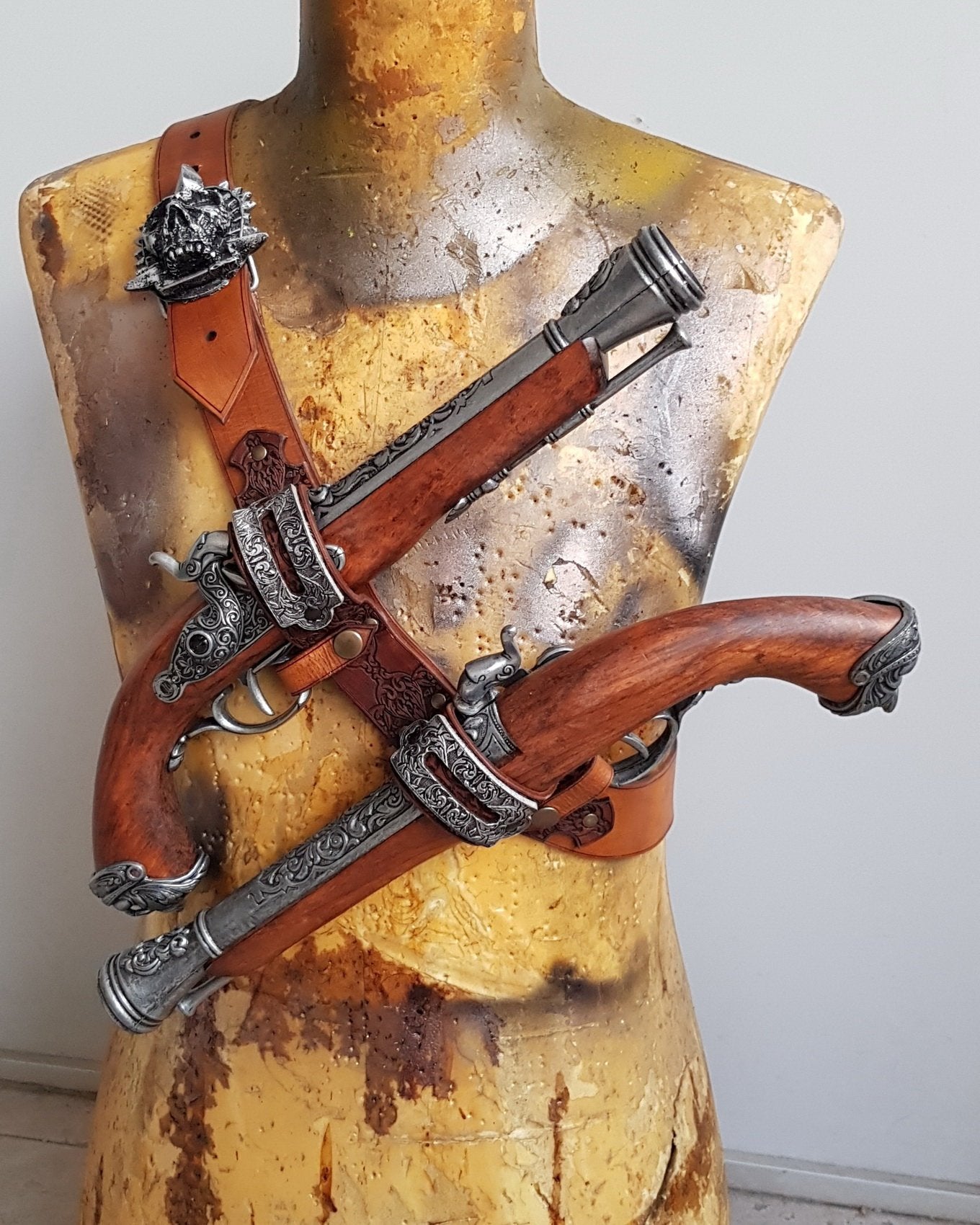 Close-up of a double leather flintlock pistol holster worn on the chest, with engraved silver buckles and dark etched leatherwork. Designed in the spirit of Edward Kenway from Assassins Creed, this pirate baldric is a stunning LARP accessory or cosplay piece. Ideal for pirate-themed costumes, fantasy events, or Caribbean rogue adventurers.