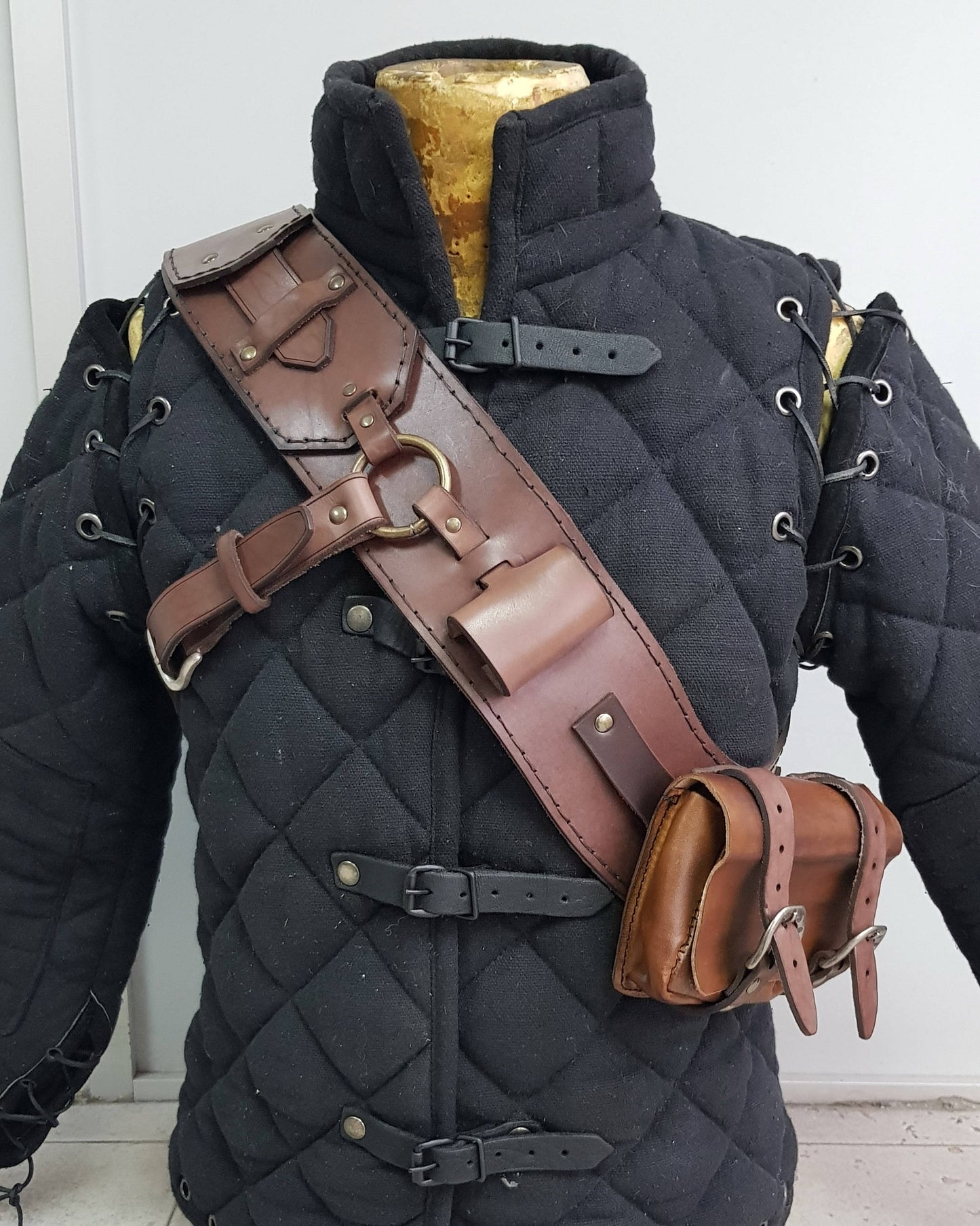 Leather baldric inspired by Witcher 3 ursine armor, handcrafted with brown leather and functional pouches, worn over padded gambeson. Ideal for witcher cosplay, Geralt costume, LARP armor, and fantasy RPG outfits. A premium bear school leather bandolier and monster hunter gear accessory for witcher costume builds.