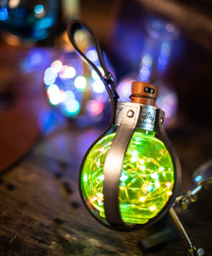 Handmade Magic Light Potion Bottle for steampunk or fantasy cosplay, featuring colorful LED lights inside a clear PET plastic bottle with brown leather straps. 250ml capacity, belt loop included, powered by LR44 alkaline batteries, safe for aerial transport.