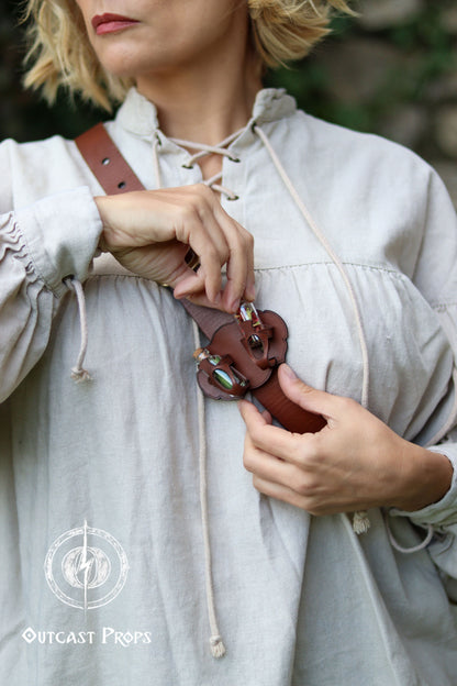 Person wearing a light-colored garment with a brown leather belt. Belt Potion holder for two small bottles. Made of leather for adventurers, steampunk, alchemist, healers, cosplay or just to keep spices