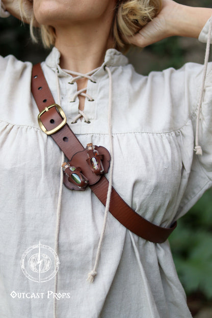 Person wearing a brown leather belt with a gold buckle on a light-colored outfit. Belt Potion holder for two small bottles. Made of leather for adventurers, steampunk, alchemist, healers, cosplay or just to keep spices
