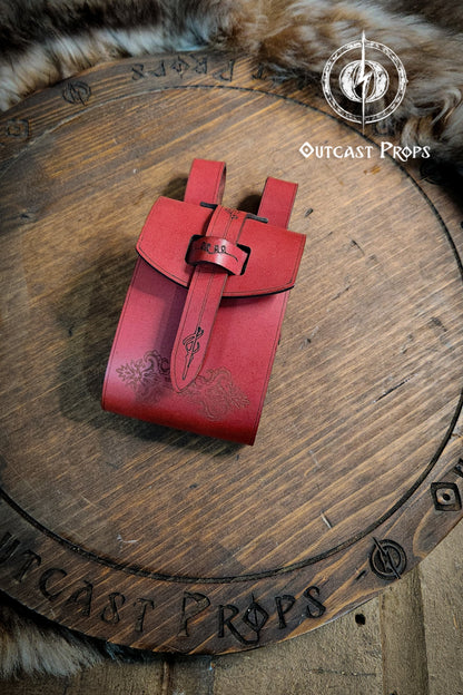 Red leather pouch on a wooden surface with 'Outcast Props' branding. Leather Vial Case for 3 plastic vials. Adventurers, steampunk, alchemist, healers, cosplay or just to keep spices
