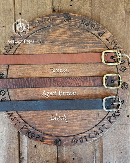 30 Plain leather belt. Wooden display with leather belts labeled 'Brown', 'Aged Brown', and 'Black' on a wooden background.