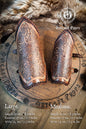 Pair of leather gauntlets with intricate designs on a wooden board, branded 'Outcast Props'. Viking Leather Bracers with Norse Knot Engraving for LARP Cosplay Medieval Fantasy Roleplay Handmade Armor Custom Gear for Men or Women