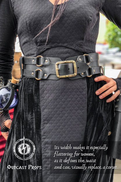 Close-up of the wide black leather belt for LARP and fantasy costumes, worn over a quilted dark dress. This unisex adventurer belt is ideal for carrying potion vials, bags, and tools during cosplay or live-action roleplay. The rugged, handcrafted buckles and reinforced design ensure both comfort and durability, making this pirate or alchemist belt a must-have for immersive adventures.