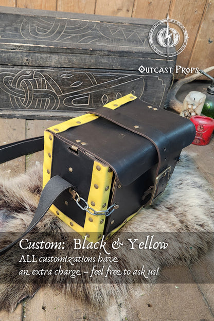 Black and yellow bag with leather straps on a wooden surface, featuring Outcast Props branding. Alchemist leather larp Bag Potion Set for steampunk, alchemist costume, mage, witch, chef, healer or assassin cosplay. Natural Leather Bag